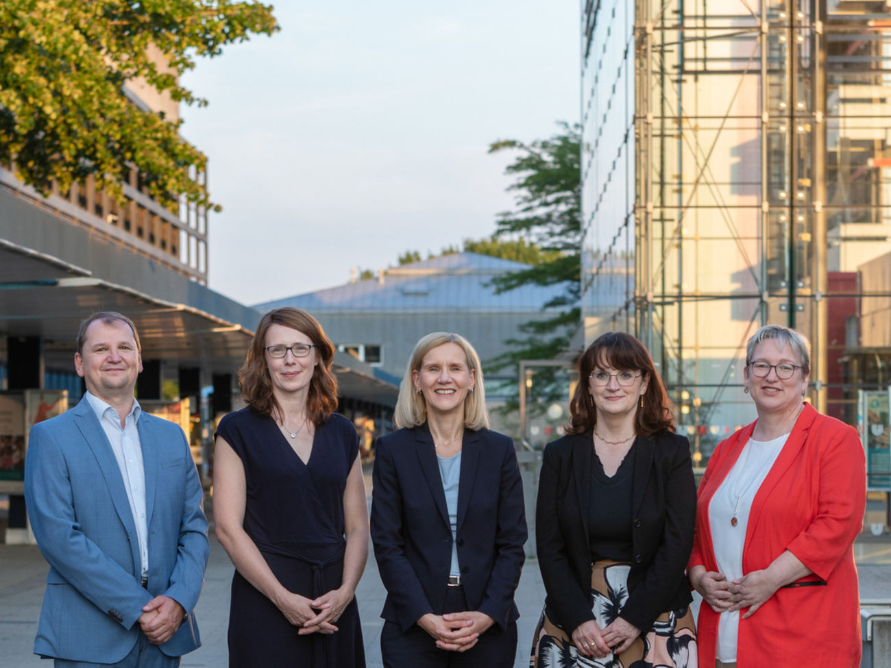 The five members of the University Executive Board stand together on the university boulevard.