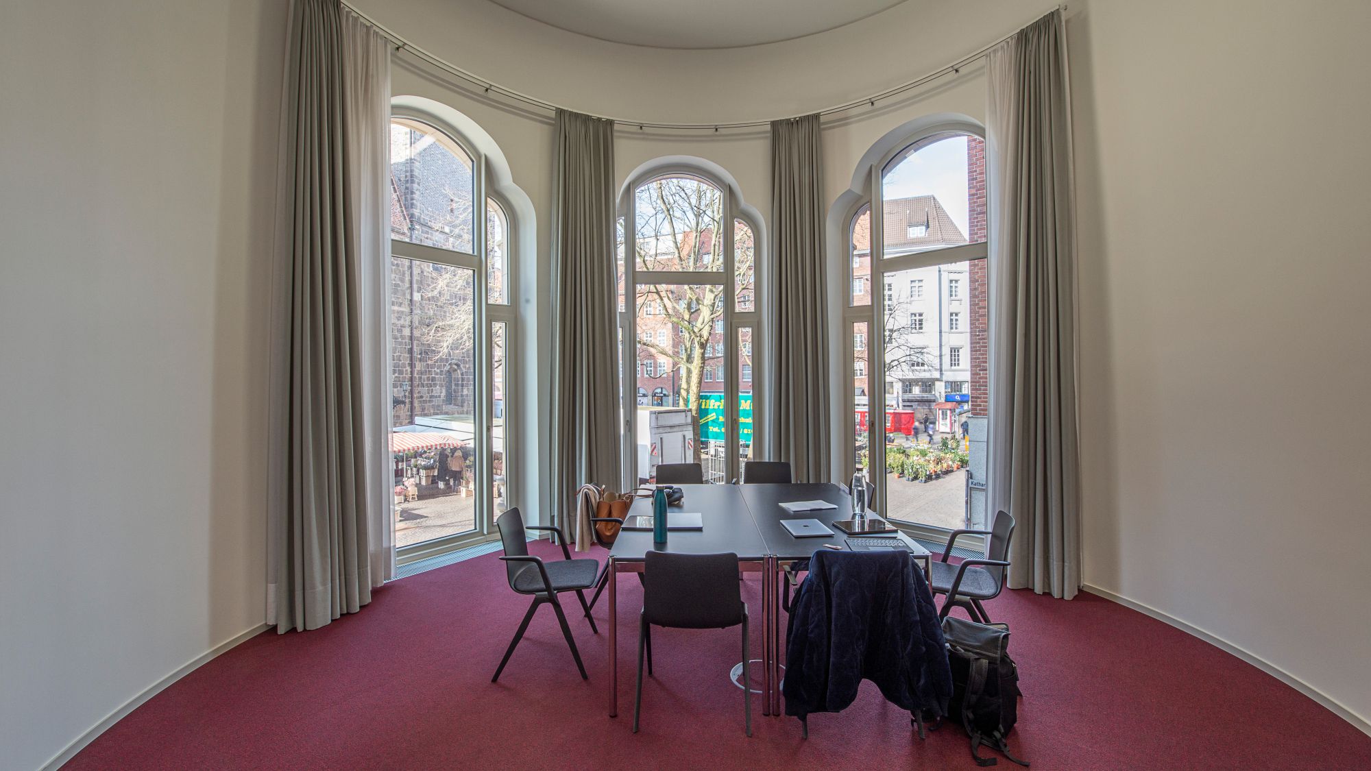 Blick in den runden Raum, dessen Fenster zur Innenstadt zeigen.