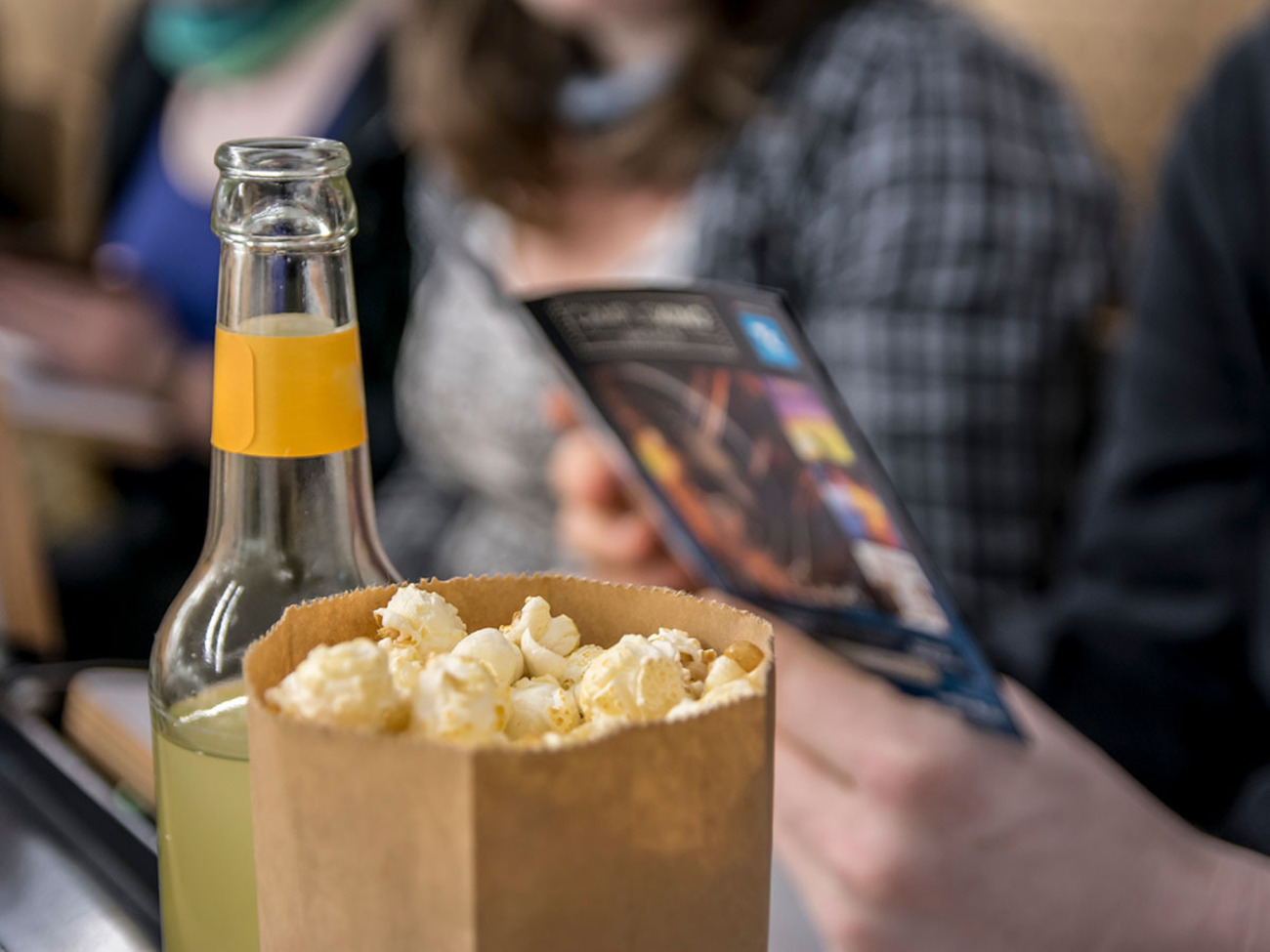 Eine Tüte Popcorn und eine Getränkeflasche auf einem Tisch