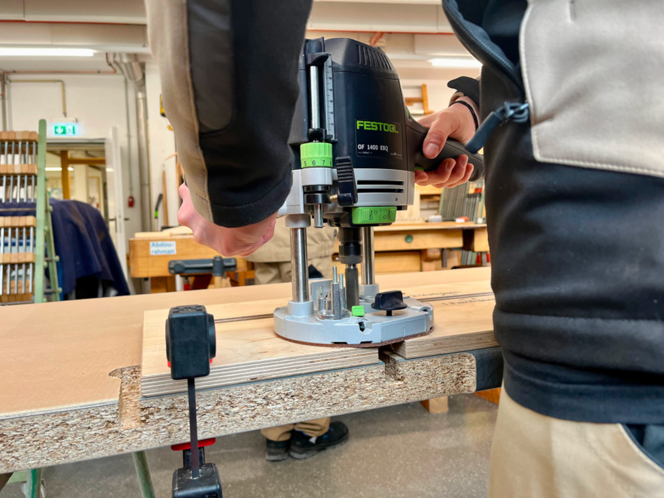 Someone is using a power router on a countertop