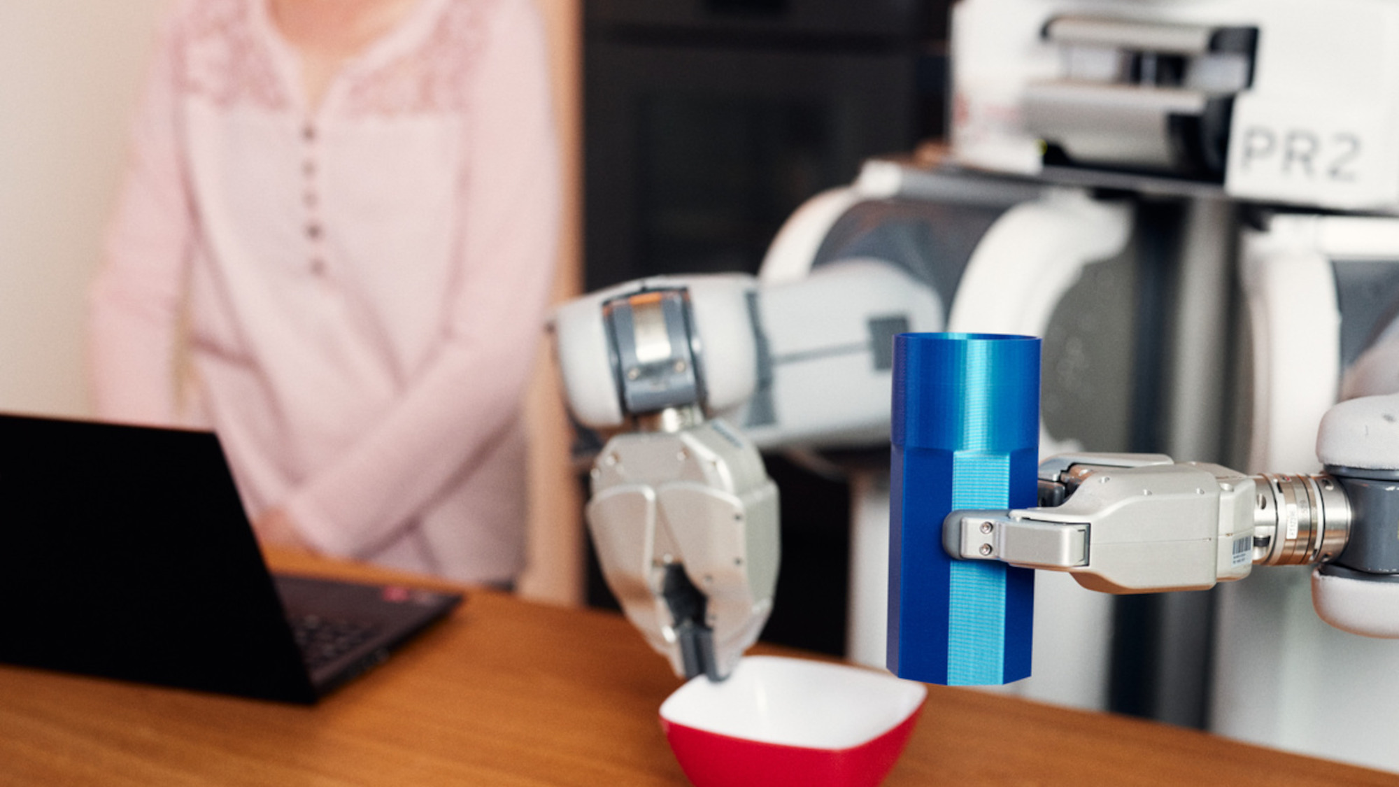 A robot handles a bowl and practices everyday tasks