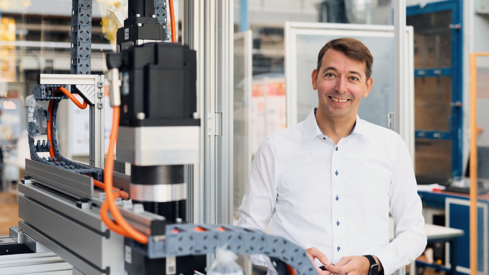Daniel Meyer stands next to a machinery