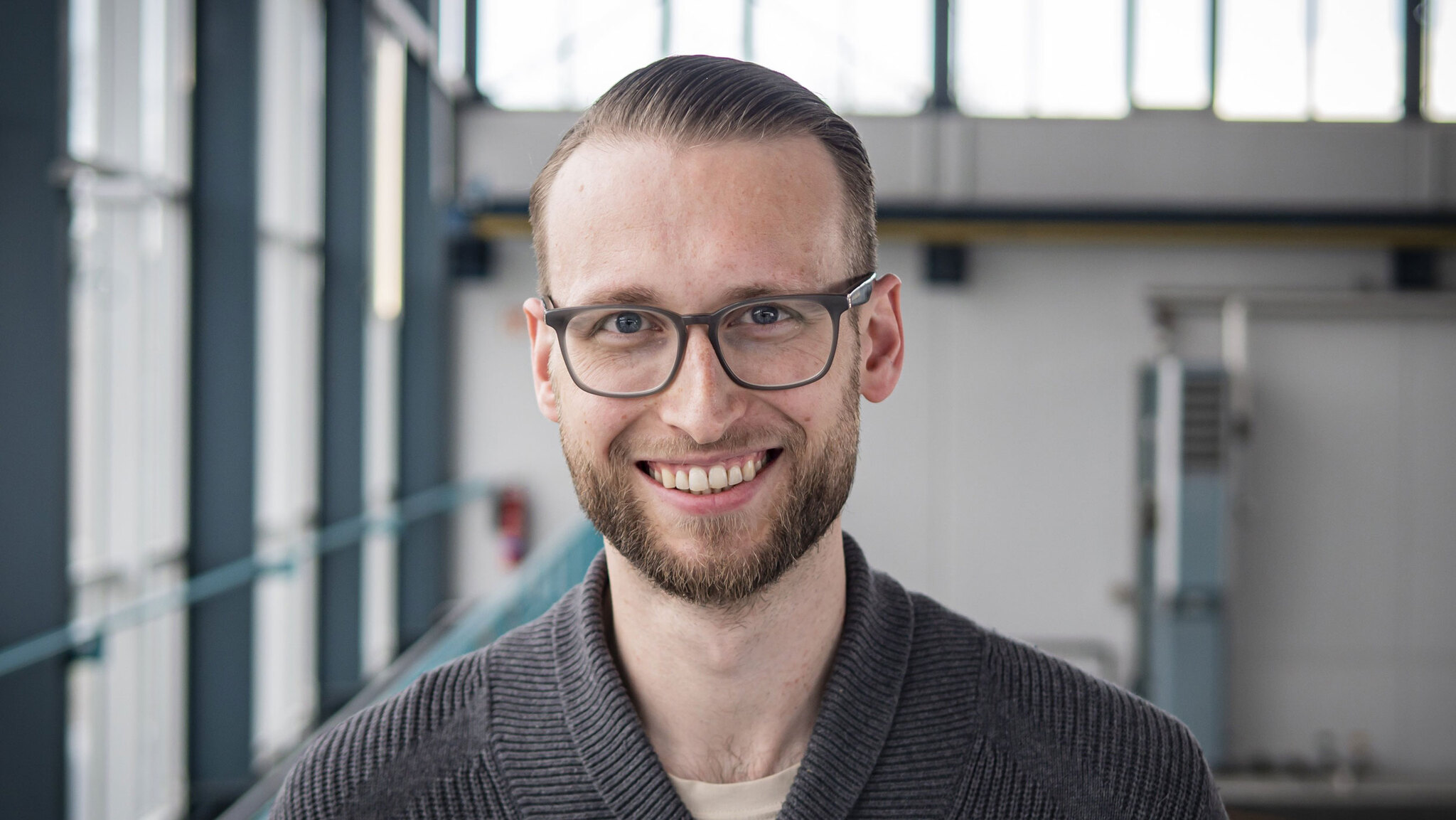 The picture captures the portrait of a man smiling at the camera.
