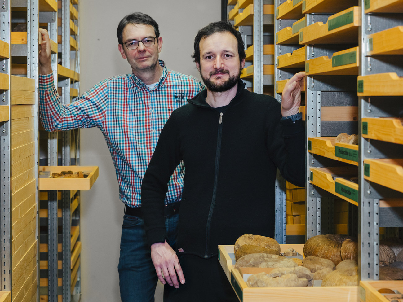 Jens Lehmann and Martin Krogmann stand in a room where the objects are stored.