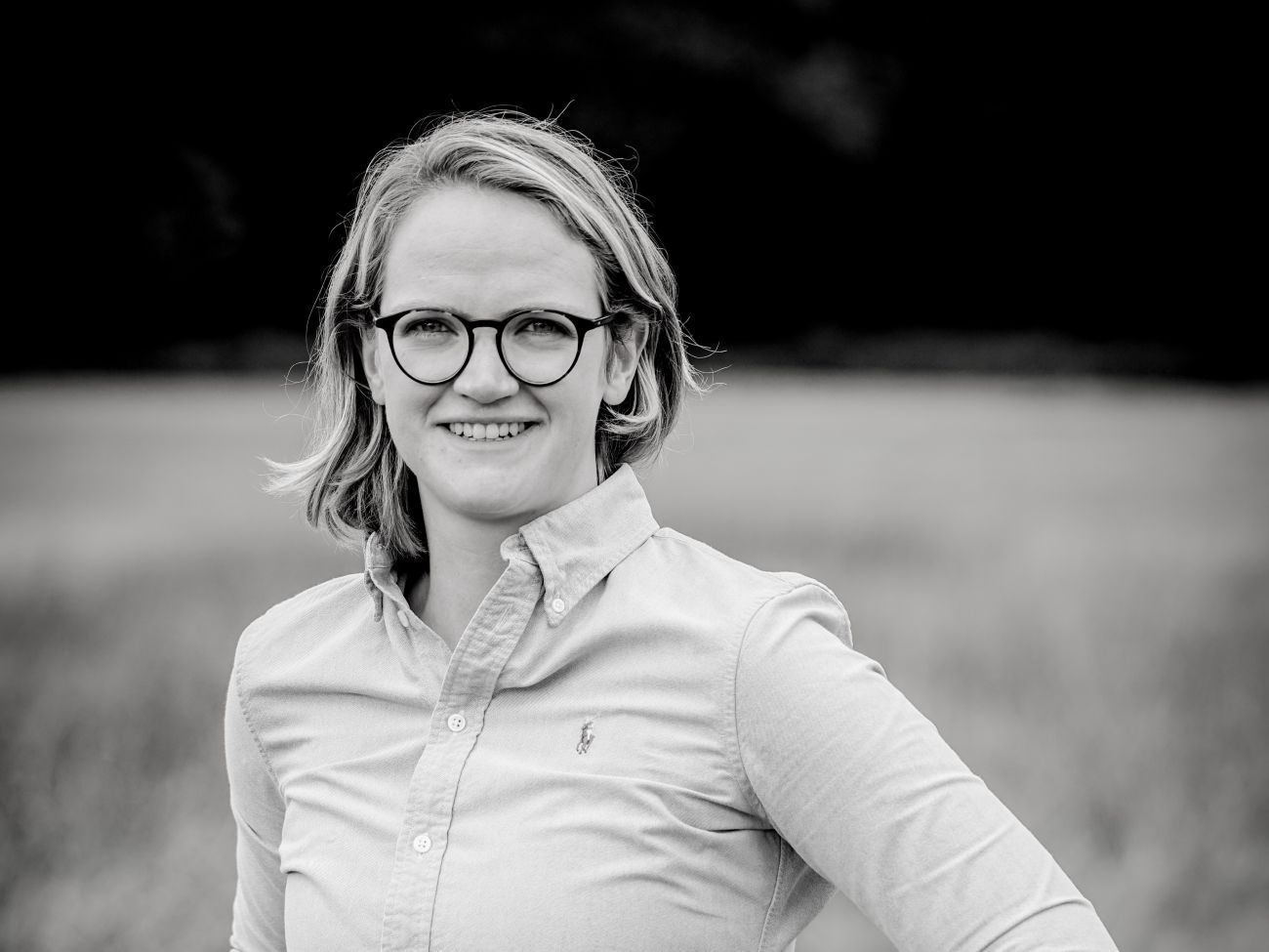 A woman smiles at the camera