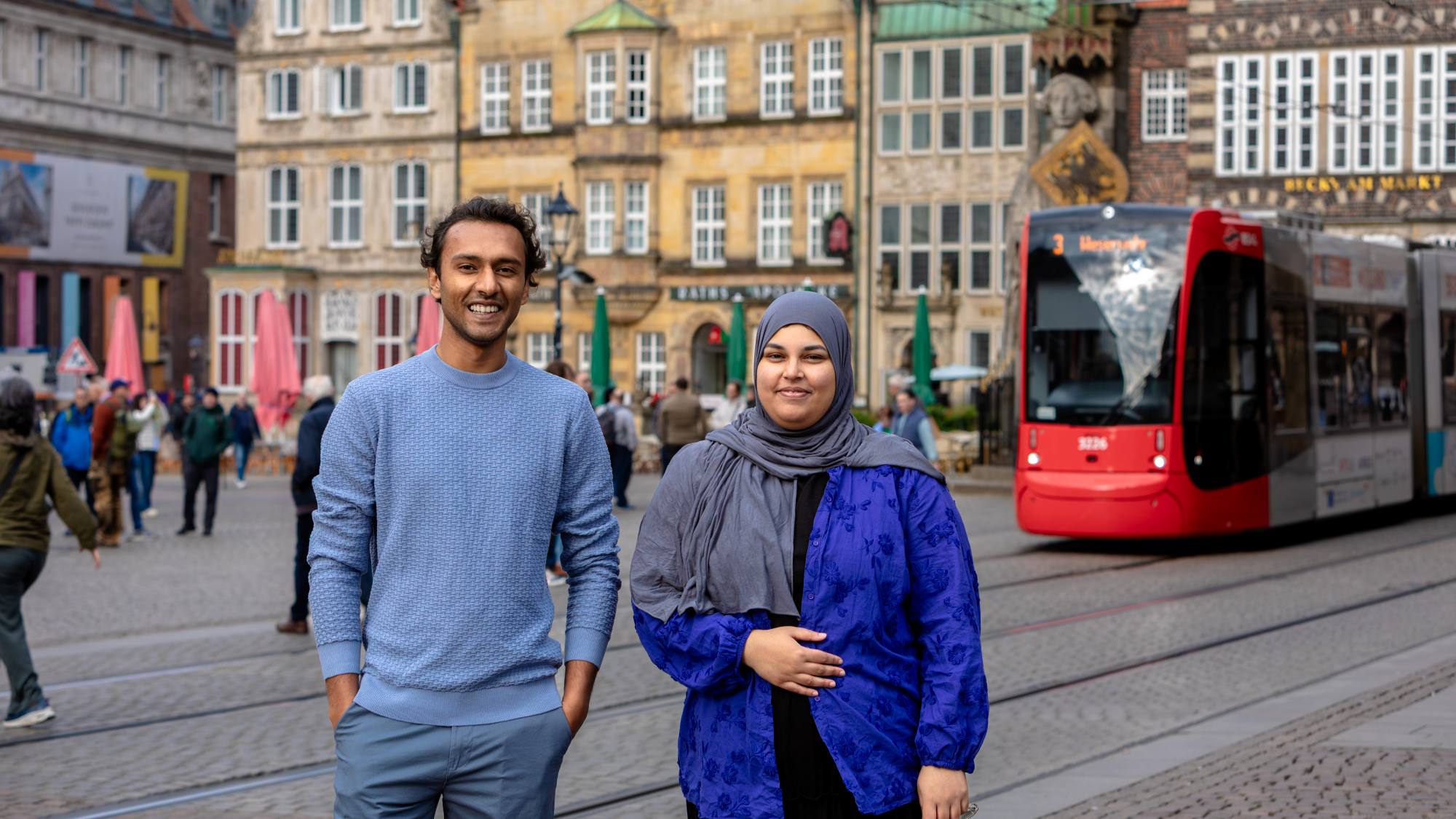 A man and a woman are standing in downtown Bremen.