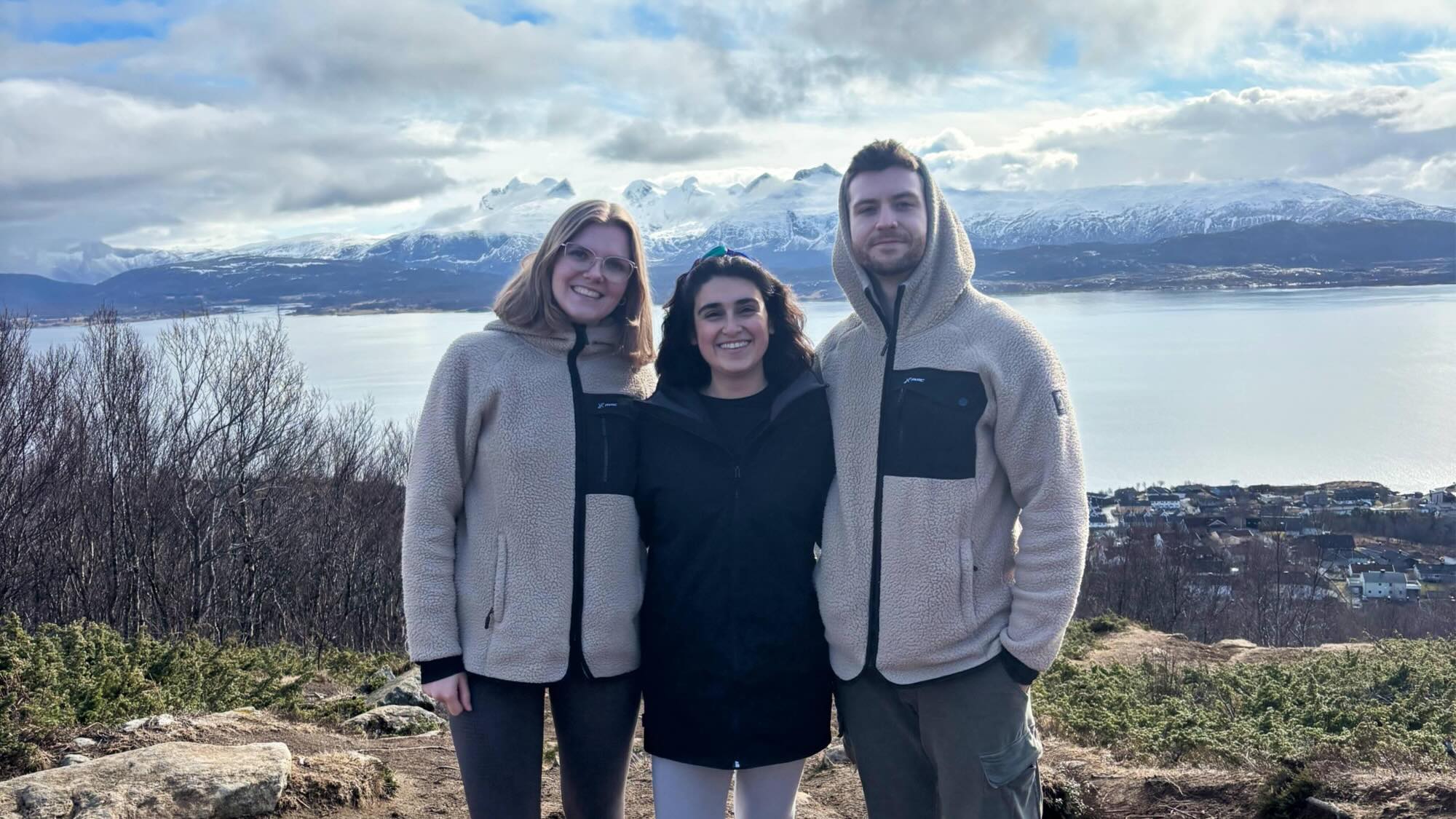 A photo of Rena, Jaro, and Kübra against a backdrop of icy mountains.
