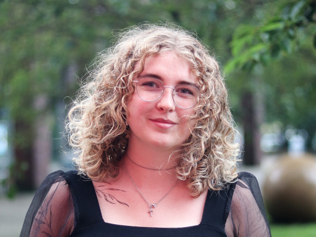 A person smiles at the camera.