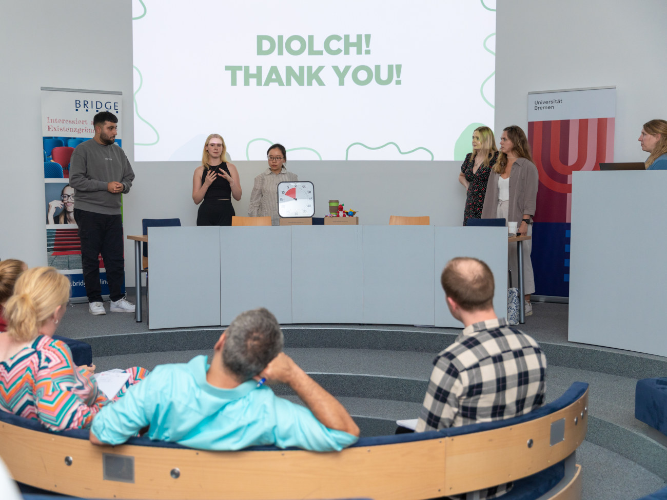 Six students standing in front of a jury to present their ideas.